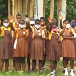Students from school in Ghana waving.